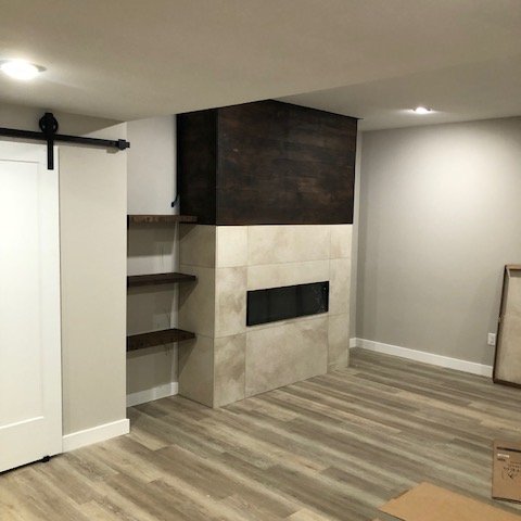 Finished basement remodel with COREtec luxury vinyl flooring and modern tile finishes