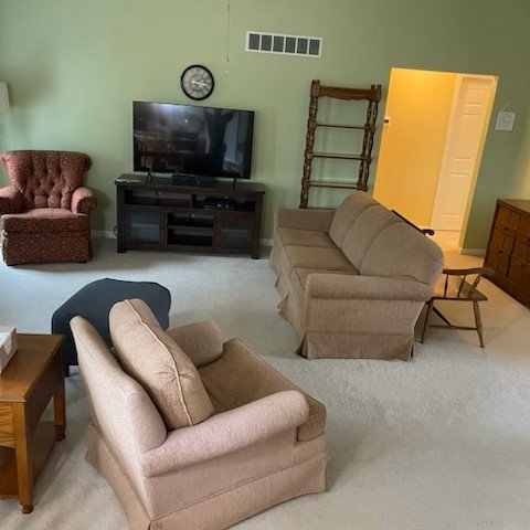 Before: living room with the original wood-look floor.