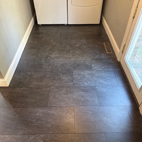 The same Embra Slate luxury vinyl tile in the laundry room.